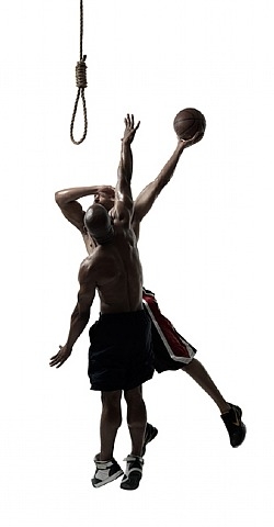 Two basketball players jumping to put basketball into a noose
