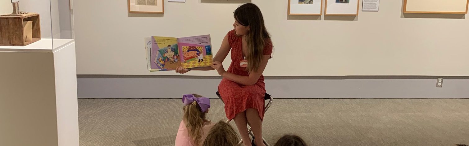 Image of a person reading to a group of children.